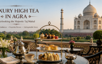 Luxury high tea in Agra overlooking the Taj Mahal with premium tea, gourmet pastries, elegant terrace seating, and panoramic monument views.