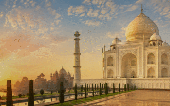 The Taj Mahal glowing in the soft light of sunrise and the golden hues of sunset in Agra, India