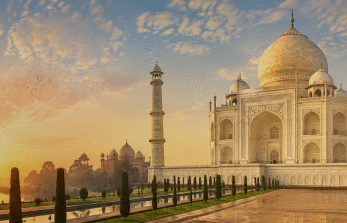 The Taj Mahal glowing in the soft light of sunrise and the golden hues of sunset in Agra, India